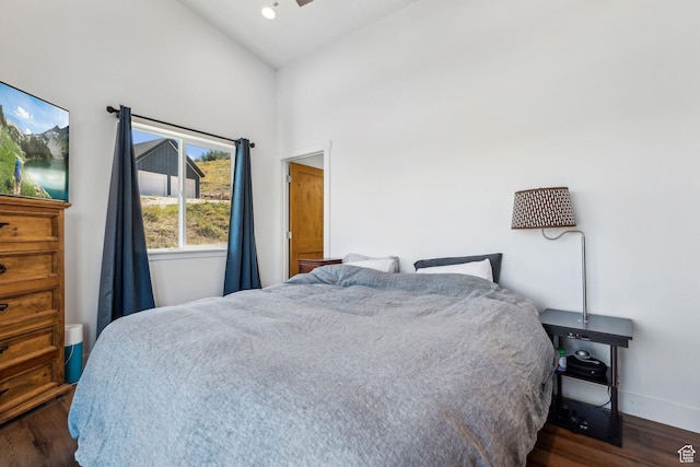 bedroom featuring lofted ceiling, dark wood finished floors, baseboards, and recessed lighting