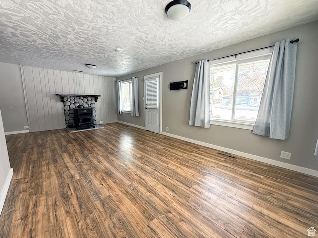55 N 400 E, Heber City, UT 84032 - unfurnished living room featuring wood finished floors, baseboards, a stone fireplace, and a textured ceiling