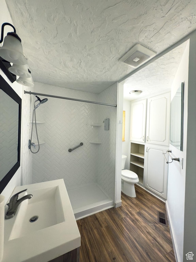 55 N 400 E, Heber City, UT 84032 - bathroom featuring a shower stall, vanity, wood finished floors, toilet, and a textured ceiling