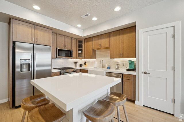 6698 Purple Poppy Ln Unit 11, Park City, UT 84098 - kitchen with a kitchen bar, appliances with stainless steel finishes, backsplash, and a sink