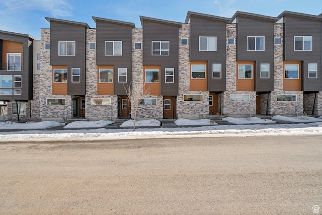 townhome / multi-family property with stone siding
