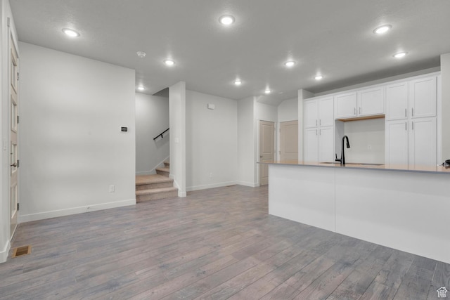 1786 N 180 E, Heber City, UT 84032 - kitchen featuring visible vents, white cabinets, open floor plan, light wood-style floors, and a sink