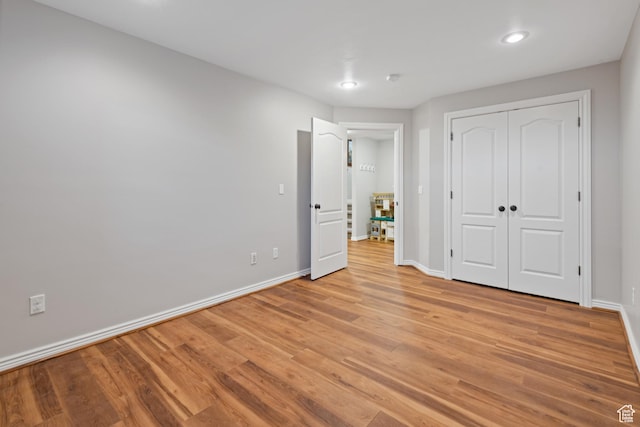 34 N Scenic Hills Cir E, North Salt Lake, UT 84054 - unfurnished bedroom with baseboards, light wood-style floors, recessed lighting, and a closet