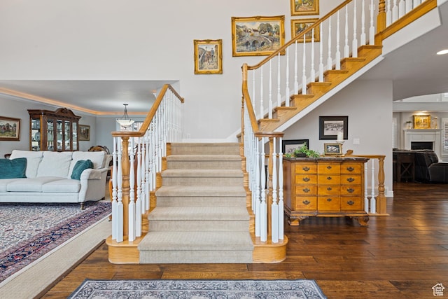 34 N Scenic Hills Cir E, North Salt Lake, UT 84054 - staircase featuring wood-type flooring, crown molding, and a fireplace