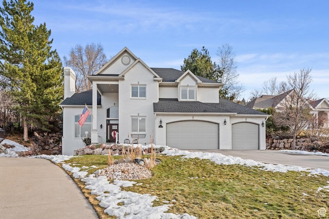 34 N Scenic Hills Cir E, North Salt Lake, UT 84054 - traditional home featuring a chimney, concrete driveway, brick siding, and an attached garage