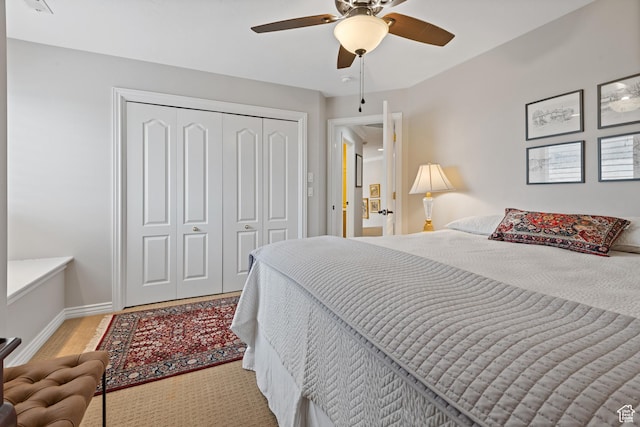34 N Scenic Hills Cir E, North Salt Lake, UT 84054 - bedroom featuring a closet, baseboards, ceiling fan, and wood finished floors