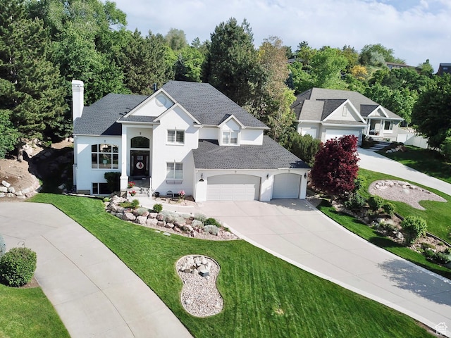 34 N Scenic Hills Cir E, North Salt Lake, UT 84054 - view of front of house featuring concrete driveway, a front yard, a shingled roof, a chimney, and an attached garage