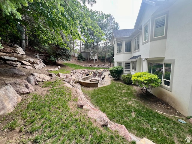 34 N Scenic Hills Cir E, North Salt Lake, UT 84054 - view of yard with an outdoor fire pit and a patio