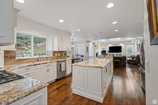 34 N Scenic Hills Cir E, North Salt Lake, UT 84054 - kitchen with stainless steel appliances, open floor plan, a center island, white cabinetry, and recessed lighting