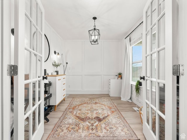 1463 S Lake View Terrace Rd, Saratoga Springs, UT 84045 - interior space with a chandelier, french doors, a decorative wall, and wood finished floors