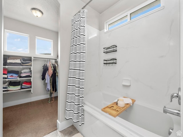 1463 S Lake View Terrace Rd, Saratoga Springs, UT 84045 - bathroom featuring a healthy amount of sunlight, a spacious closet, baseboards, and shower / bath combination with curtain