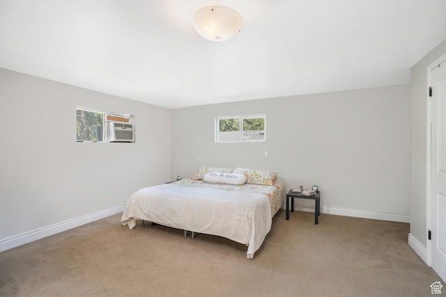 bedroom featuring baseboards and light colored carpet