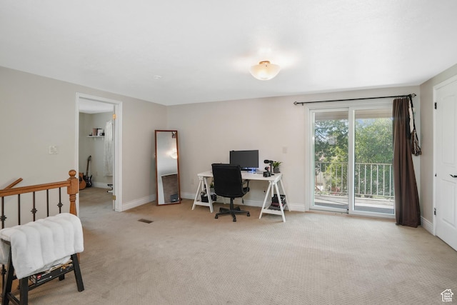 office with baseboards and light colored carpet