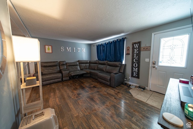 living area with a textured ceiling and dark wood-style flooring