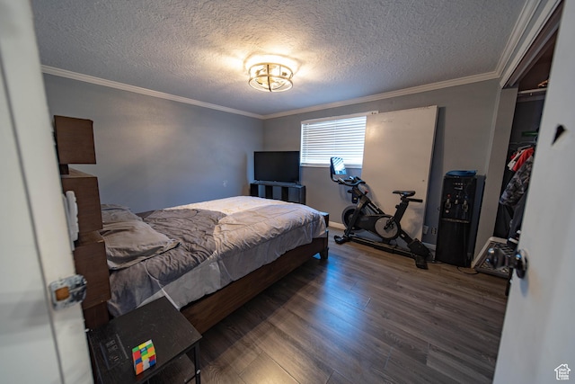 bedroom featuring crown molding, a textured ceiling, and dark wood-style flooring