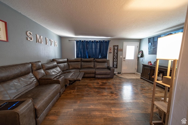 living room with dark wood-style floors and a textured ceiling