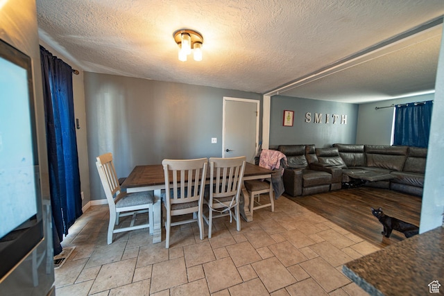 dining space with a textured ceiling
