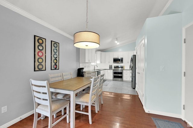 59 Belmore Dr, Kaysville, UT 84037 - dining space with crown molding, light wood-type flooring, vaulted ceiling, and baseboards