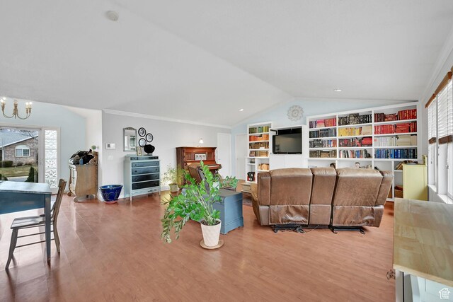 59 Belmore Dr, Kaysville, UT 84037 - living room featuring lofted ceiling, plenty of natural light, wood finished floors, and a notable chandelier