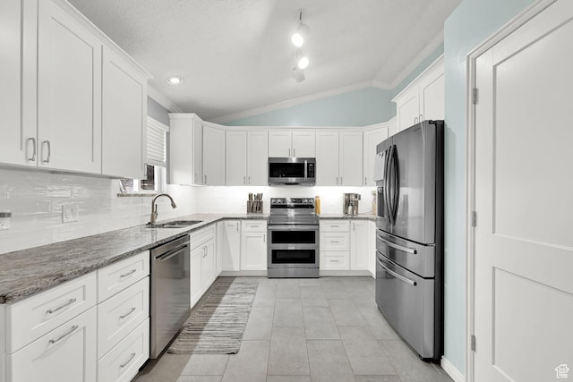 59 Belmore Dr, Kaysville, UT 84037 - kitchen featuring dark stone counters, stainless steel appliances, a sink, and white cabinetry