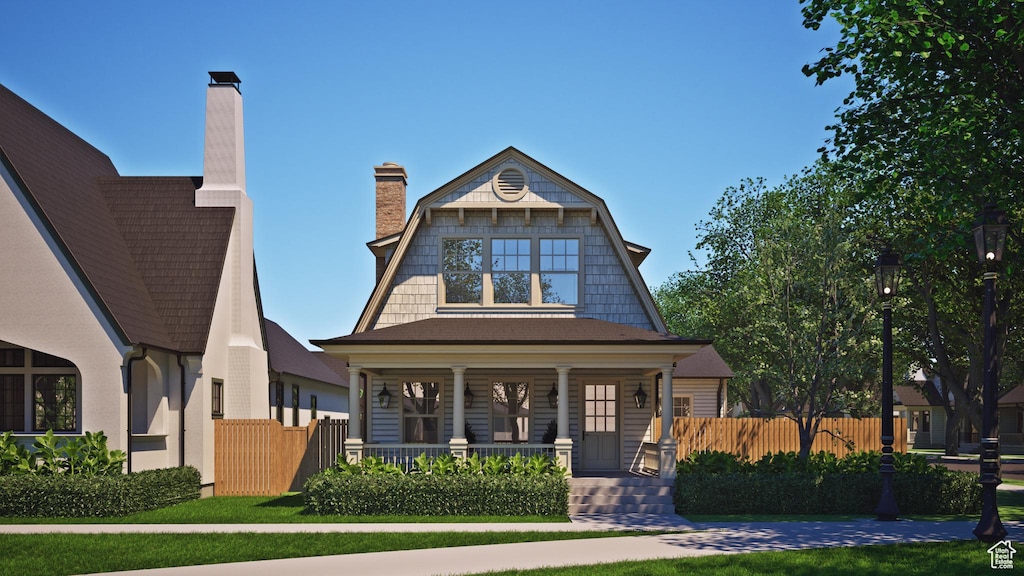 451 S Main St Unit 136, Vineyard, UT 84058 - view of front of home featuring a porch, fence, and a chimney