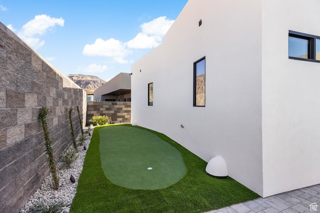 view of yard with a fenced backyard and a mountain view