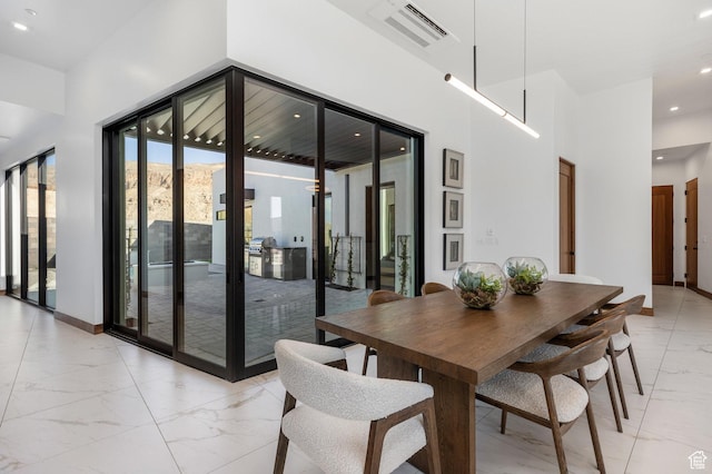 dining space with baseboards, visible vents, a towering ceiling, marble finish floor, and recessed lighting