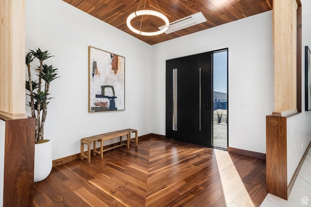 entrance foyer with wooden ceiling, dark wood finished floors, and baseboards