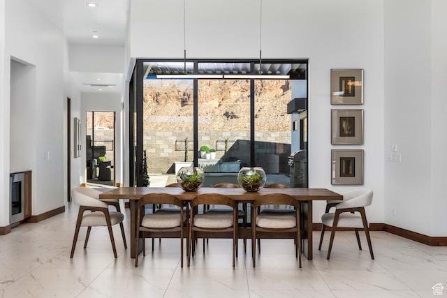 dining area with marble finish floor and baseboards