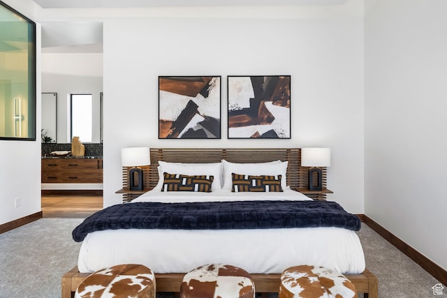 bedroom featuring carpet and baseboards