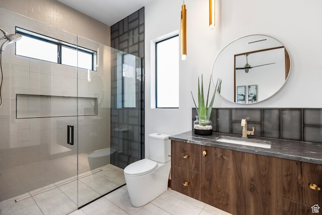 full bathroom featuring tile patterned flooring, toilet, a shower stall, and vanity
