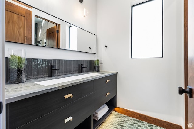 bathroom featuring a sink and double vanity
