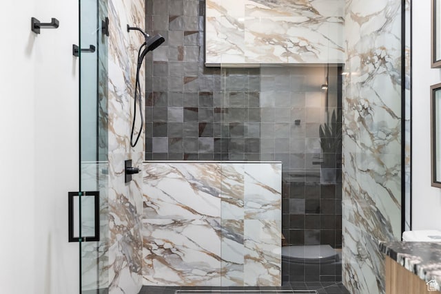 bathroom with a marble finish shower