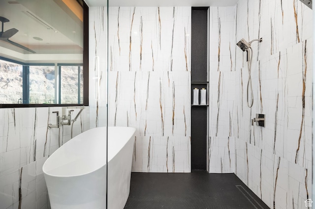 bathroom featuring a freestanding bath, tile walls, and walk in shower