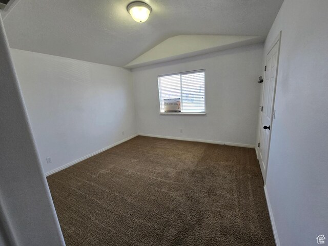 8204 N Cedar Springs Rd E Unit U-12, Eagle Mountain, UT 84005 - empty room with carpet flooring, baseboards, vaulted ceiling, and a textured ceiling