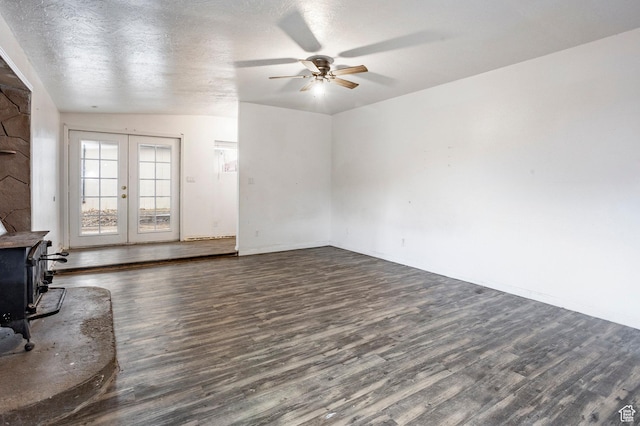 170 S 500 E, Duchesne, UT 84021 - living area featuring dark wood finished floors, ceiling fan, a wood stove, a textured ceiling, and french doors