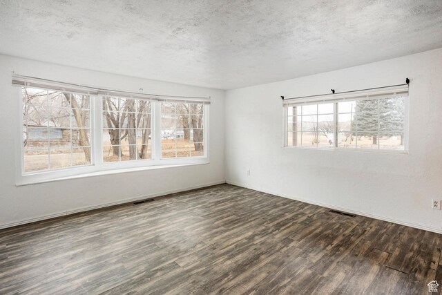 170 S 500 E, Duchesne, UT 84021 - unfurnished room featuring dark wood-style floors, a textured ceiling, and visible vents