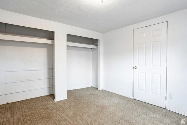 170 S 500 E, Duchesne, UT 84021 - unfurnished bedroom featuring a textured ceiling and light colored carpet