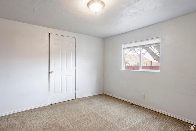 170 S 500 E, Duchesne, UT 84021 - empty room featuring baseboards, a textured ceiling, and light colored carpet