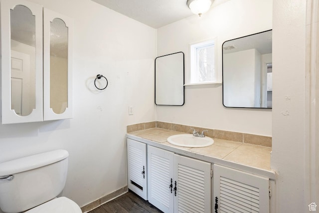 170 S 500 E, Duchesne, UT 84021 - bathroom with toilet, wood finished floors, vanity, and baseboards