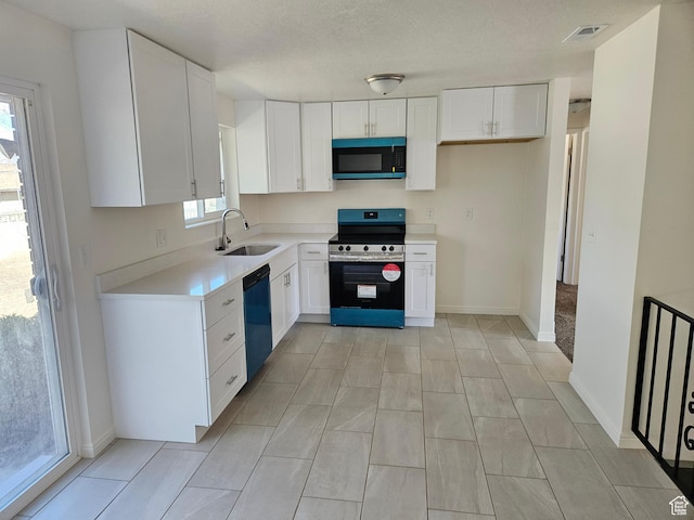kitchen with white cabinets, dishwashing machine, stainless steel electric range, light countertops, and a sink