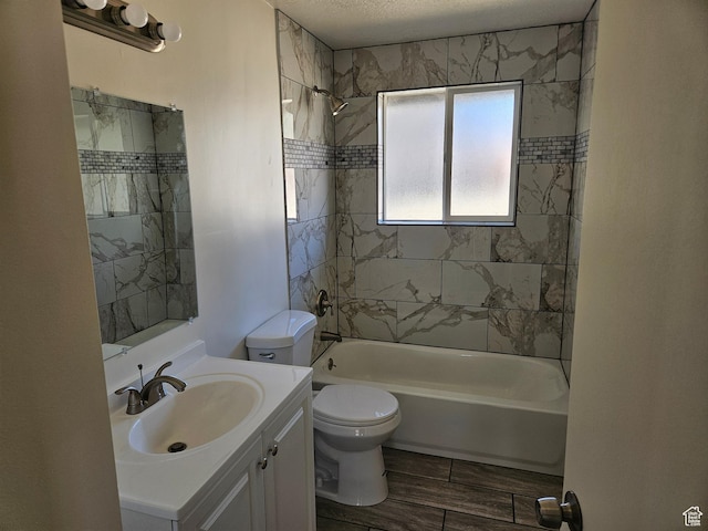 bathroom featuring bathtub / shower combination, toilet, wood tiled floor, vanity, and a textured ceiling