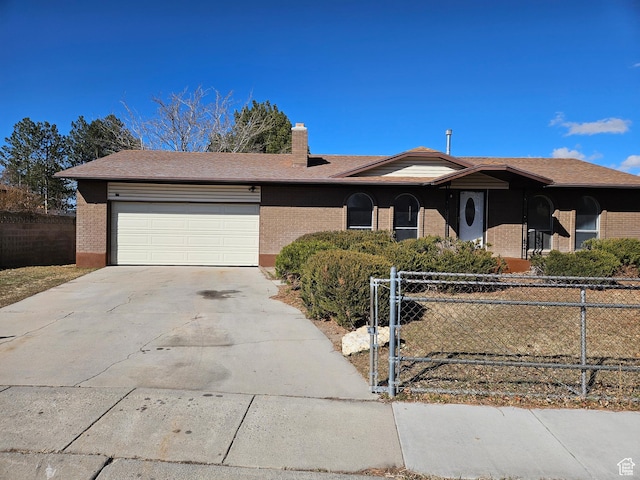 ranch-style home featuring a garage, brick siding, driveway, and fence