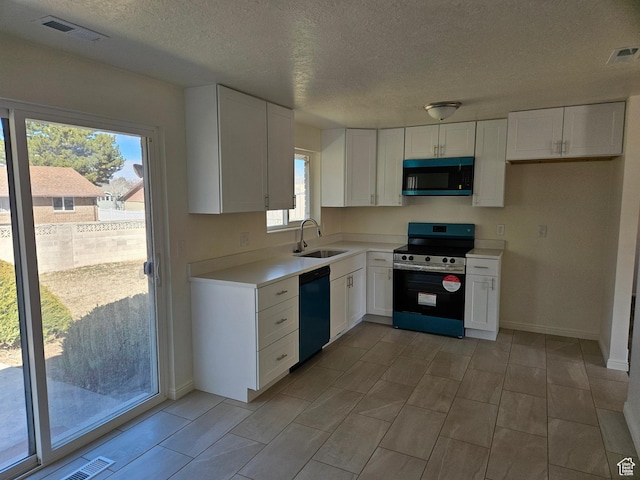 kitchen with dishwasher, a sink, visible vents, and stainless steel electric stove