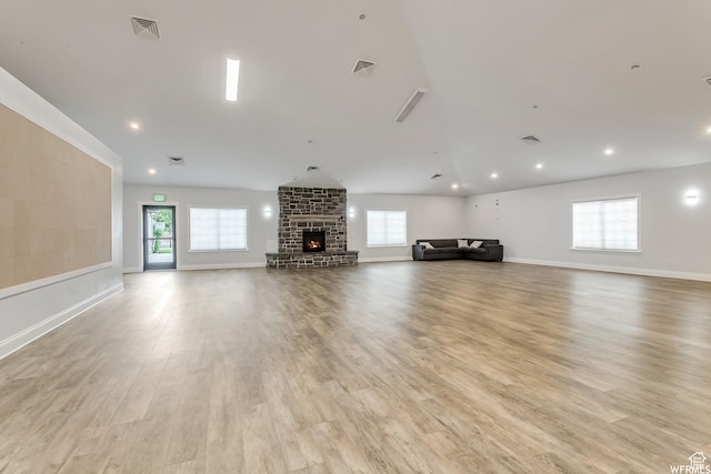 1829 W 1120 S Unit 128, Springville, UT 84663 - unfurnished living room featuring a large fireplace, light wood-type flooring, visible vents, and a healthy amount of sunlight