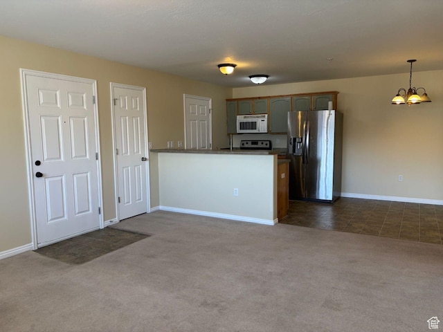 1829 W 1120 S Unit 128, Springville, UT 84663 - kitchen with decorative light fixtures, dark countertops, dark carpet, appliances with stainless steel finishes, and a peninsula