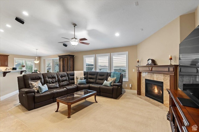 living room with recessed lighting, light carpet, a fireplace, and baseboards