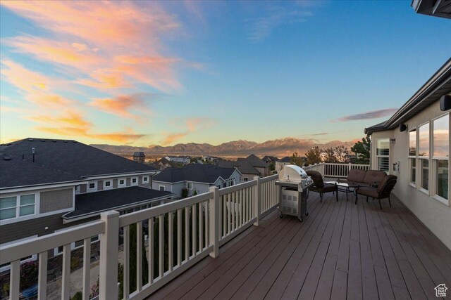 wooden deck with a residential view, a mountain view, and an outdoor living space