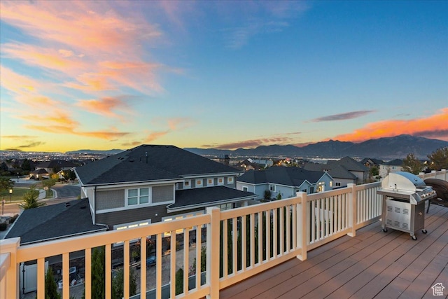 deck with grilling area, a residential view, and a mountain view