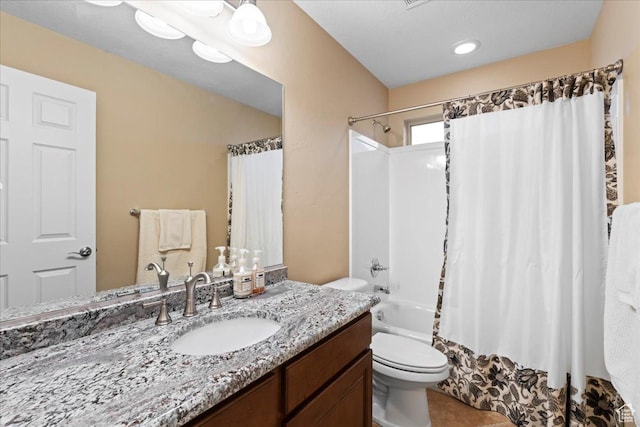 full bath featuring shower / bath combo, vanity, and toilet